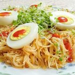 Eating microgreens with noodles